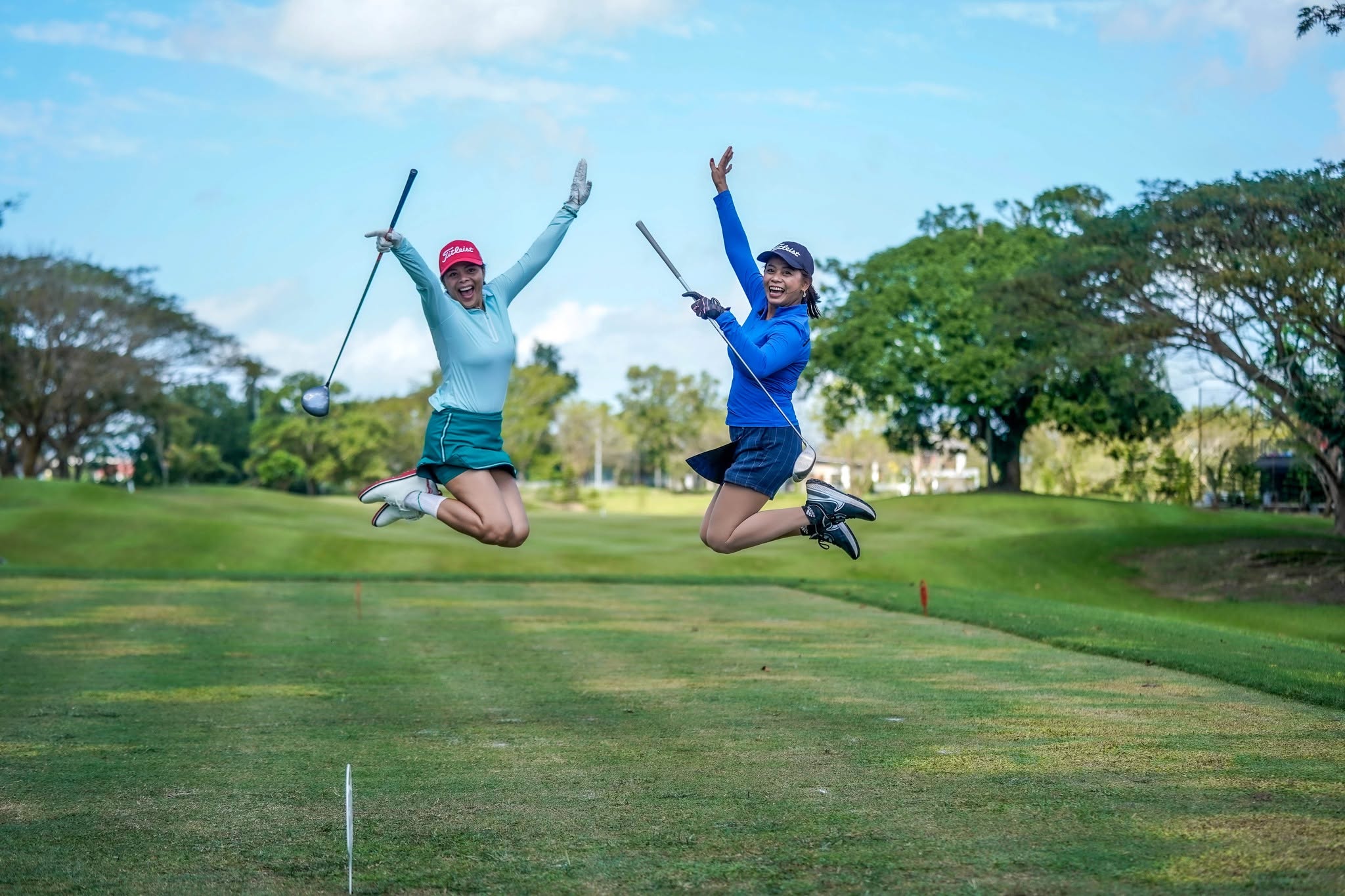 Two golfers jumping with joy on the Summit Point fairway