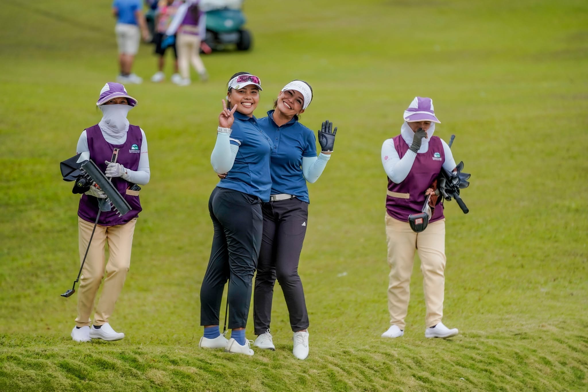 Two lady golfers smiling on course