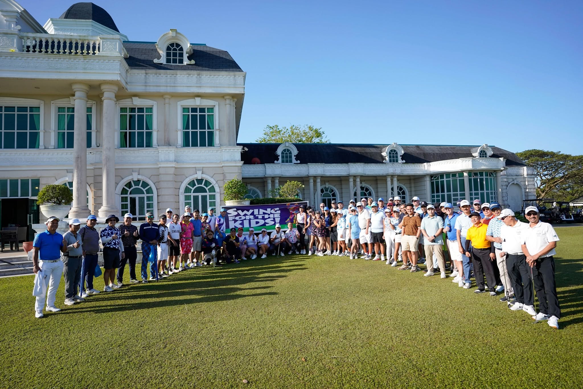 Four golfers posing together
